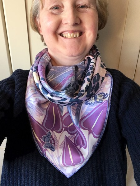 Jaguar Quetzal 90cm silk scarf by Hermès in a cowboy cowl knot