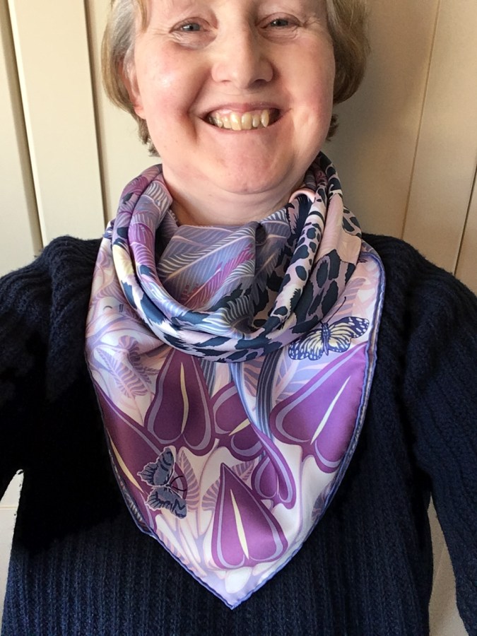 Jaguar Quetzal 90cm silk scarf by Hermès in a cowboy cowl knot